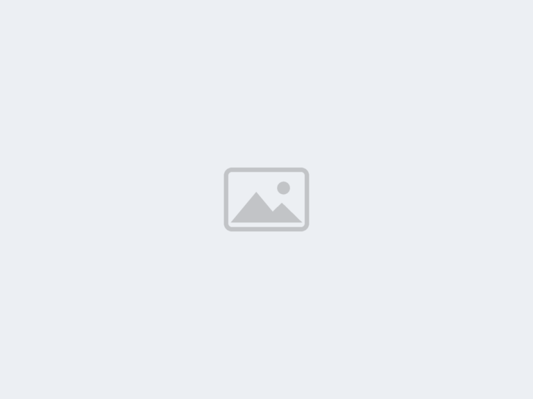 Photo placeholder - replace with plumber working on pipes under a kitchen sink